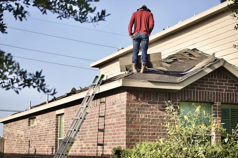Professional roofer working on a residential roof in Country Club View
